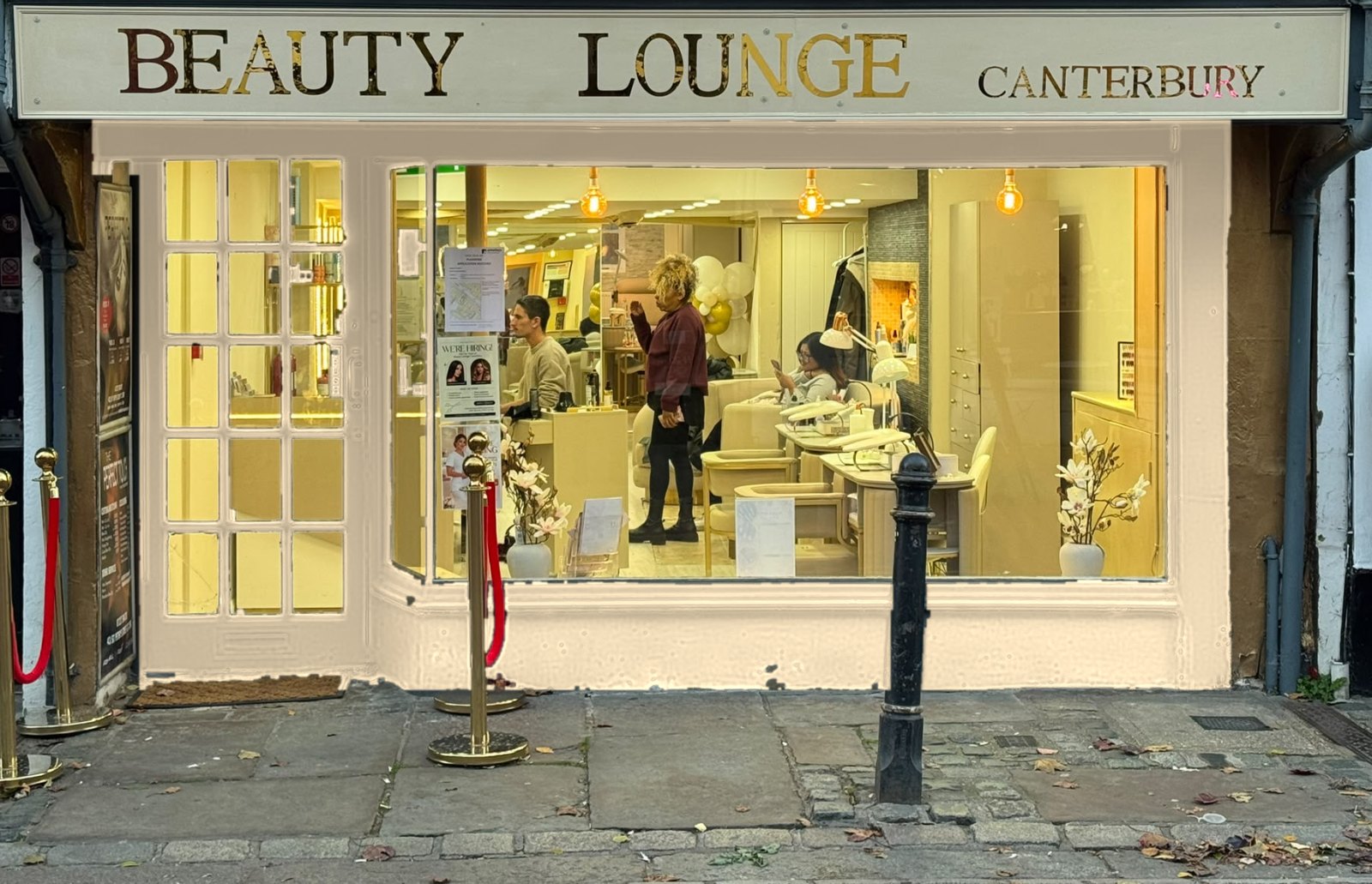 Shop front on St Peter's Street with brass posts and red ropes